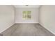Cozy bedroom featuring neutral paint, carpet, and a window for natural light at 2326 Sand Dollar Sw Ct, Atlanta, GA 30331