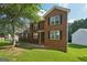 Classic brick residence with a symmetrical facade, enhanced by lush landscaping and greenery at 2326 Sand Dollar Sw Ct, Atlanta, GA 30331