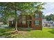 Traditional two-story brick home with a well-manicured front yard, under a large tree at 2326 Sand Dollar Sw Ct, Atlanta, GA 30331
