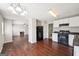 Open-concept kitchen flows into living area with fireplace, showcasing modern appliances at 2326 Sand Dollar Sw Ct, Atlanta, GA 30331