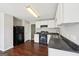 Kitchen with appliances, white cabinets, and wood flooring at 2326 Sand Dollar Sw Ct, Atlanta, GA 30331