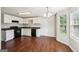 Bright kitchen with black appliances, white cabinets, and wood flooring at 2326 Sand Dollar Sw Ct, Atlanta, GA 30331