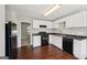 Kitchen with appliances, white cabinets, and wood flooring at 2326 Sand Dollar Sw Ct, Atlanta, GA 30331