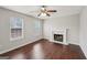 Inviting living room with abundant natural light, a traditional fireplace, and stylish ceiling fan at 2326 Sand Dollar Sw Ct, Atlanta, GA 30331