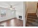 Open-concept living room featuring a fireplace, ceiling fan, and staircase at 2326 Sand Dollar Sw Ct, Atlanta, GA 30331