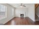 Cozy living space boasting a classic fireplace, ceiling fan, and gleaming hardwood floors at 2326 Sand Dollar Sw Ct, Atlanta, GA 30331