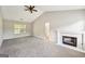 Bright living room with fireplace, ceiling fan, and access to the bathroom offers comfort and convenience at 2326 Sand Dollar Sw Ct, Atlanta, GA 30331