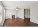 Bright living room featuring a decorative fireplace, ceiling fan, and rich hardwood flooring at 2326 Sand Dollar Sw Ct, Atlanta, GA 30331