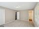 Standard bedroom featuring neutral colors, plush carpet, and access to the bathroom at 4496 Housworth Dr, Lithonia, GA 30038