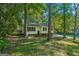 Charming home featuring dark shutters, a well maintained lawn, and mature shade trees at 4496 Housworth Dr, Lithonia, GA 30038