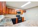 A cozy kitchen is equipped with wooden cabinets, laminate countertops, and essential appliances for everyday cooking needs at 4496 Housworth Dr, Lithonia, GA 30038