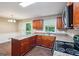 This compact kitchen features wooden cabinets, a laminate countertop, and a functional layout for meal preparation at 4496 Housworth Dr, Lithonia, GA 30038