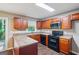 A cozy kitchen features wooden cabinets, laminate countertops, and essential appliances for convenient cooking at 4496 Housworth Dr, Lithonia, GA 30038