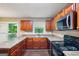 The kitchen showcases laminate countertops, black appliances, and wooden cabinets for storage and cooking at 4496 Housworth Dr, Lithonia, GA 30038