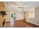 Living room boasts hardwood floors, a ceiling fan, and brick fireplace at 4496 Housworth Dr, Lithonia, GA 30038