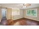 Living room featuring hardwood floors, a ceiling fan, and natural light from the window at 4496 Housworth Dr, Lithonia, GA 30038