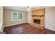 Living room with hardwood floors, brick fireplace, and lots of natural light at 4496 Housworth Dr, Lithonia, GA 30038