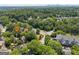 Aerial view of a charming neighborhood with lush greenery, tree-lined streets, and city skyline at 1186 Village Ne Cv, Atlanta, GA 30319
