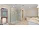 Luxurious primary bathroom featuring a seamless glass shower, garden tub, and neutral color palette at 1186 Village Ne Cv, Atlanta, GA 30319