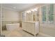 Bright primary bathroom with dual sink vanity and soaking tub at 1186 Village Ne Cv, Atlanta, GA 30319
