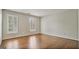 This bedroom has hardwood floors, neutral walls, and two windows for natural lighting at 1186 Village Ne Cv, Atlanta, GA 30319