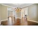 Open dining room showcasing hardwood floors, chandelier, and connectivity to other spaces at 1186 Village Ne Cv, Atlanta, GA 30319