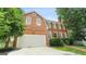 Lovely two-story brick home with attached garage, white trim, and a well-maintained lawn at 1186 Village Ne Cv, Atlanta, GA 30319