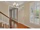 Entryway with hardwood floors, chandelier, window with shutters, and stairs to the upper level at 1186 Village Ne Cv, Atlanta, GA 30319