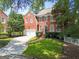 Beautiful red brick home with manicured lawn, mature trees, and a two-car garage at 1186 Village Ne Cv, Atlanta, GA 30319