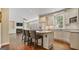 Open kitchen featuring a granite island with seating, white cabinetry and modern appliances at 1186 Village Ne Cv, Atlanta, GA 30319
