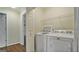 Bright laundry room featuring a washer, dryer, storage shelves, and neutral walls at 1186 Village Ne Cv, Atlanta, GA 30319