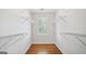 Bright walk-in closet with window and built-in shelving at 1186 Village Ne Cv, Atlanta, GA 30319