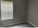 Well-lit bedroom featuring wood-look vinyl flooring and a window with white blinds at 737 Outlook Way, Atlanta, GA 30349