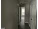 Hallway with doors and neutral paint leading to a bright room with a window at 737 Outlook Way, Atlanta, GA 30349