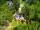 Aerial view of a beautiful house nestled among lush trees with a sprawling green lawn at 169 Knights Ct, Dallas, GA 30157
