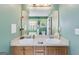 The primary bathroom features a double sink vanity and a large mirror and is painted a soothing green at 169 Knights Ct, Dallas, GA 30157