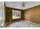 A bedroom with neutral carpet, a large window for natural light, and a ceiling fan at 169 Knights Ct, Dallas, GA 30157
