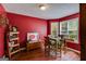A dining room area featuring a wooden table, red wall, and Coca-Cola themed decorations at 169 Knights Ct, Dallas, GA 30157