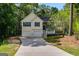 Inviting split-level home with a spacious driveway, a two-car garage and a covered porch at 169 Knights Ct, Dallas, GA 30157