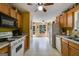 Open kitchen featuring white appliances, wood cabinets, and a view to the deck and backyard at 169 Knights Ct, Dallas, GA 30157
