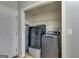 Laundry closet with a modern gray washer and dryer, ironing board, and white wire shelf at 169 Knights Ct, Dallas, GA 30157