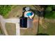 Overhead aerial view of house with inground pool, outdoor kitchen, and wooded area at 540 Benton Rd, Covington, GA 30014