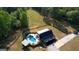 Aerial view of home with large yard and an outdoor pool and entertainment area at 540 Benton Rd, Covington, GA 30014
