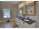 Bathroom with a dual sink vanity, wood-framed mirrors, and modern fixtures at 540 Benton Rd, Covington, GA 30014