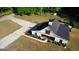 Aerial view of a modern barn style home with black roof and white siding at 540 Benton Rd, Covington, GA 30014