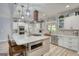 Bright open kitchen with white cabinetry, quartz countertops and stainless appliances at 540 Benton Rd, Covington, GA 30014