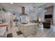 Spacious open kitchen featuring a center island, stainless appliances, and custom vent hood at 540 Benton Rd, Covington, GA 30014