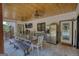 Covered outdoor kitchen has stainless steel appliances, seating, and a large screen TV at 540 Benton Rd, Covington, GA 30014