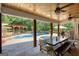 Inviting covered patio featuring an outdoor dining area and a view of the pool at 540 Benton Rd, Covington, GA 30014