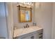 Clean and modern powder room featuring marble countertops and wood-framed mirror at 540 Benton Rd, Covington, GA 30014